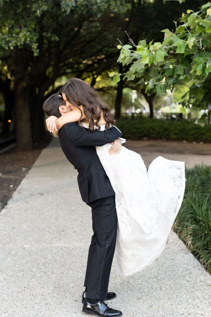 Newlyweds hugging after their wedding at The Grove Houston.