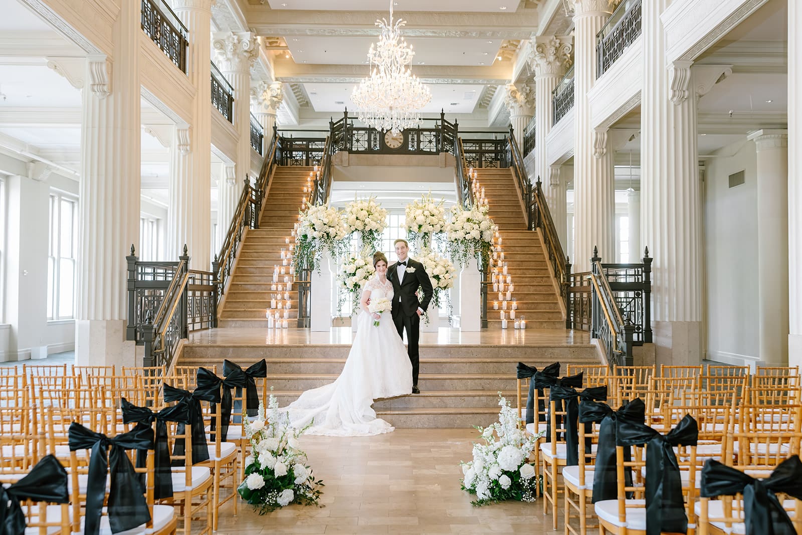 Corinthian-Houston-wedding-couple-photos-ceremony-photos-candles-on-stairs-grand-florals-for-ceremony