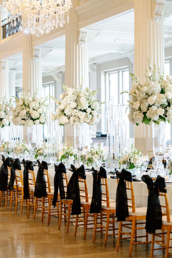 Corinthian-Houston-black-white-wedding-white-green-tall-floral-arrangements-bow-on-chair-wedding