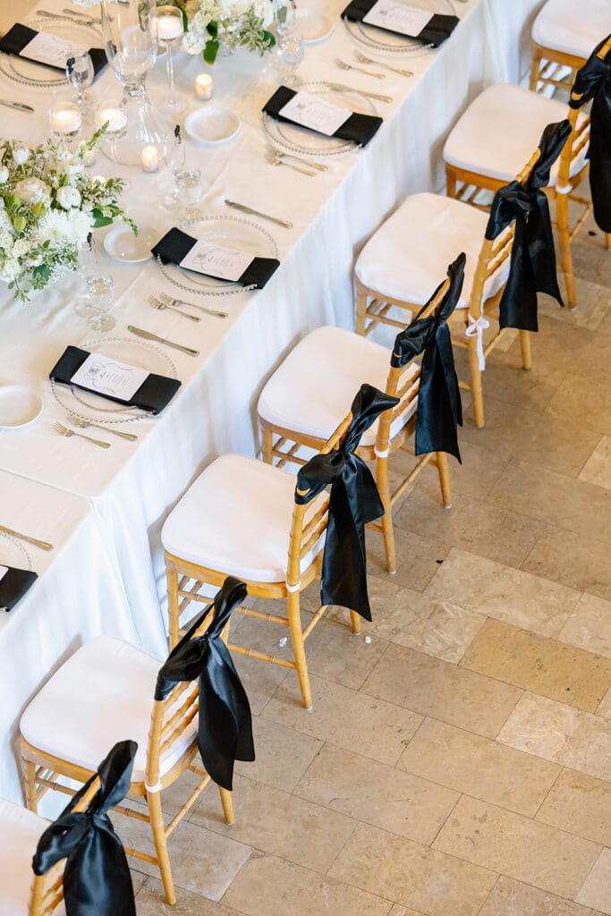 Corinthian-Houston-black-white-wedding-centerpieces-black-bow-wedding-chairs